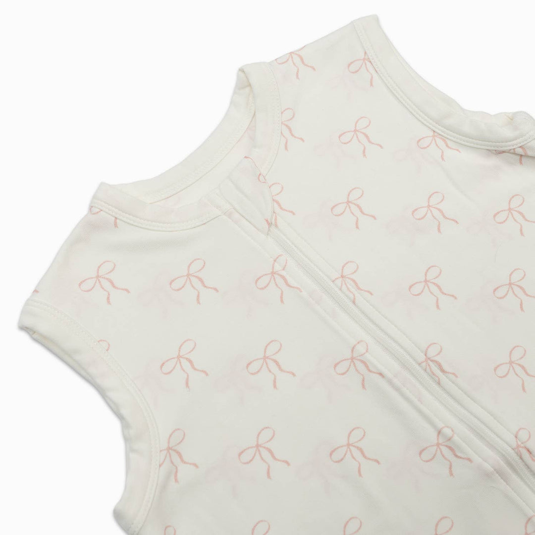 Baby wrap with pink bow pattern on a white background