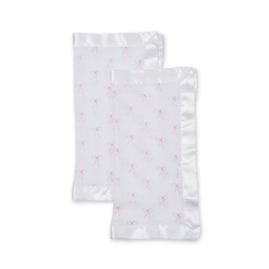 Two white pillowcases with pink floral patterns on a light gray background