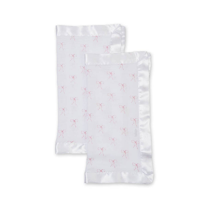 Two white pillowcases with pink floral patterns on a light gray background