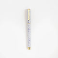 Decorative pen with crystal design on a white background