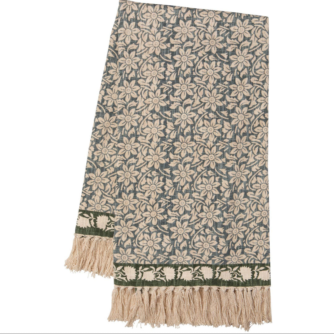 Floral patterned throw blanket with fringe on a white background