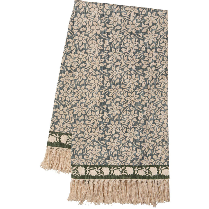 Floral patterned throw blanket with fringe on a white background