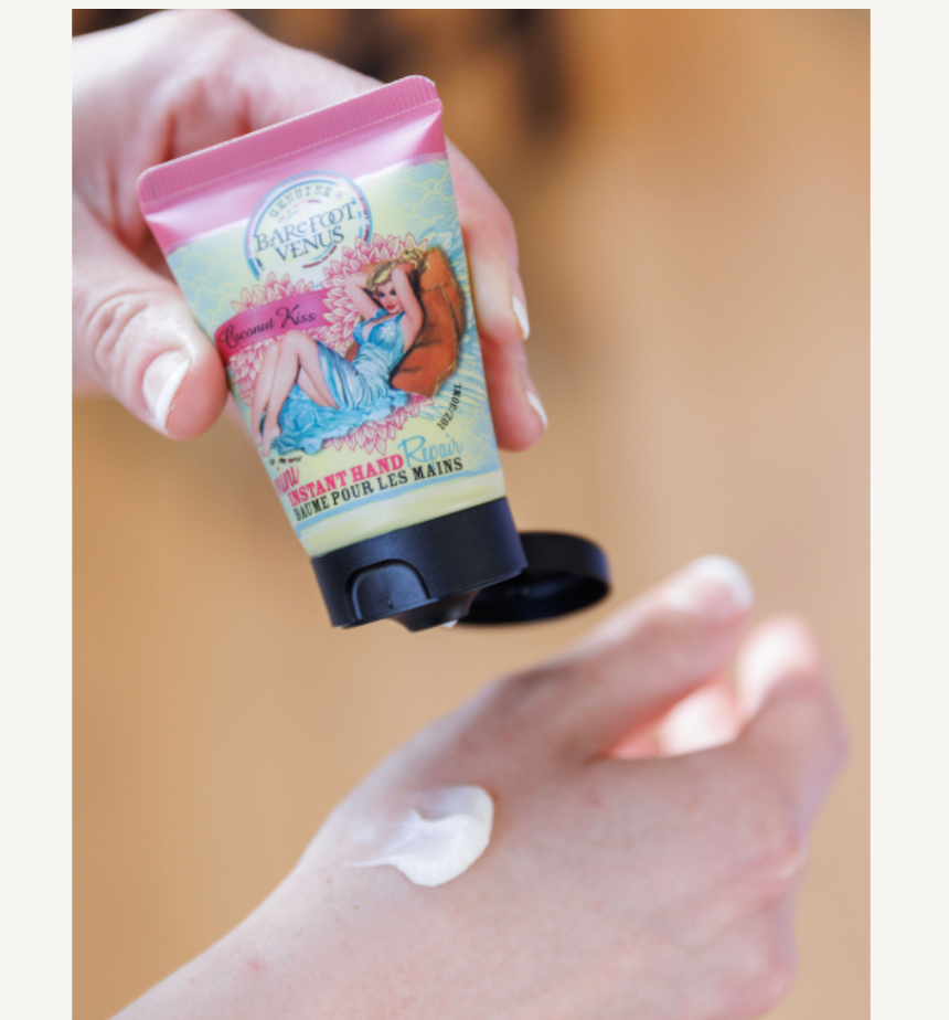Hand holding a small tube of hand cream with a colorful label against a beige background