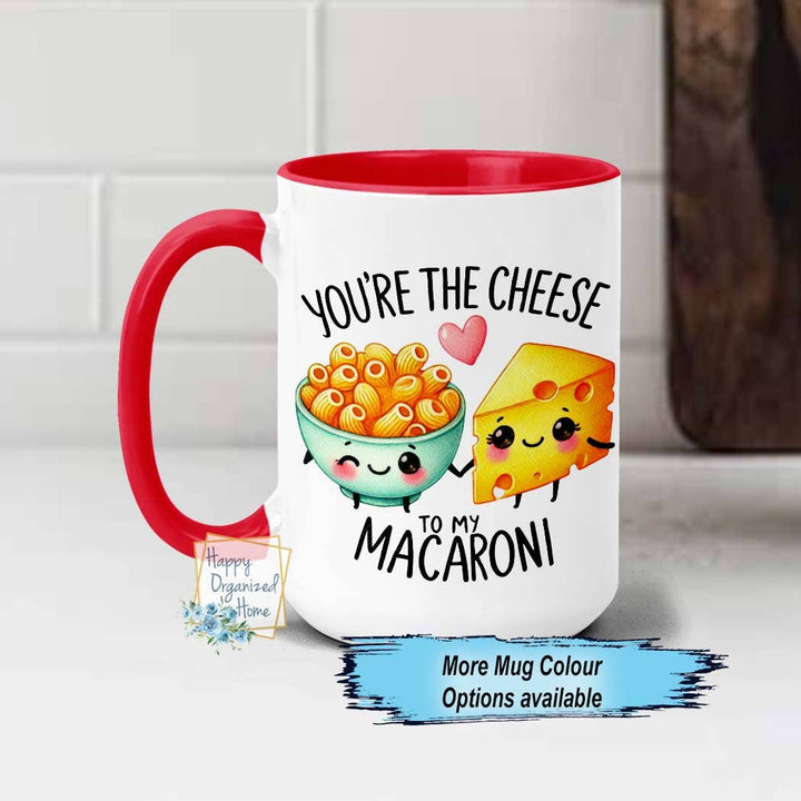 Mug with cartoon macaroni and cheese design and text on a white background