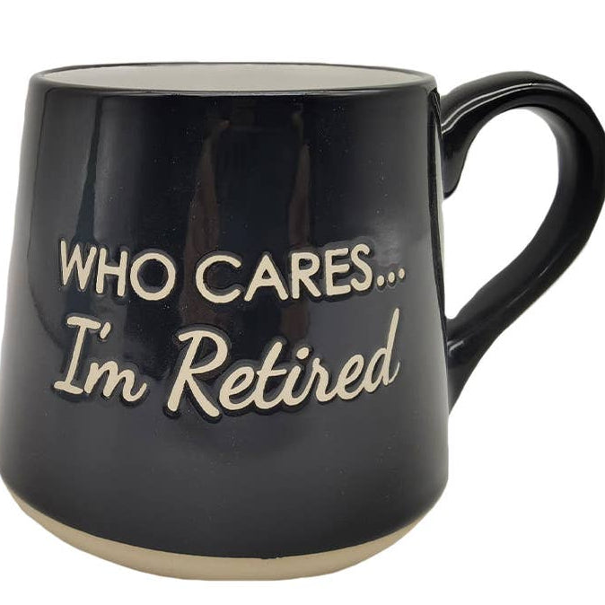 A black ceramic mug with a light beige base and handle, featuring the text &