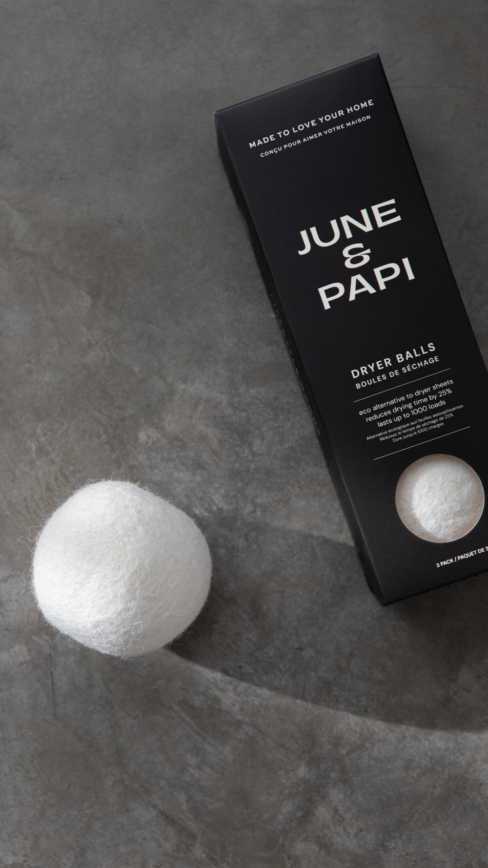 June & Papi dryer balls with packaging on a gray surface