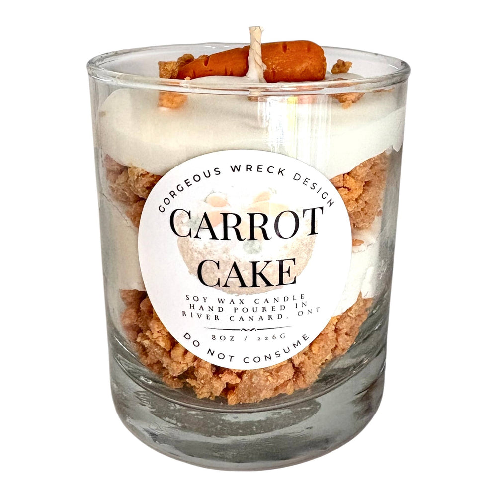 Carrot cake candle in a glass jar with a visible label on a white background