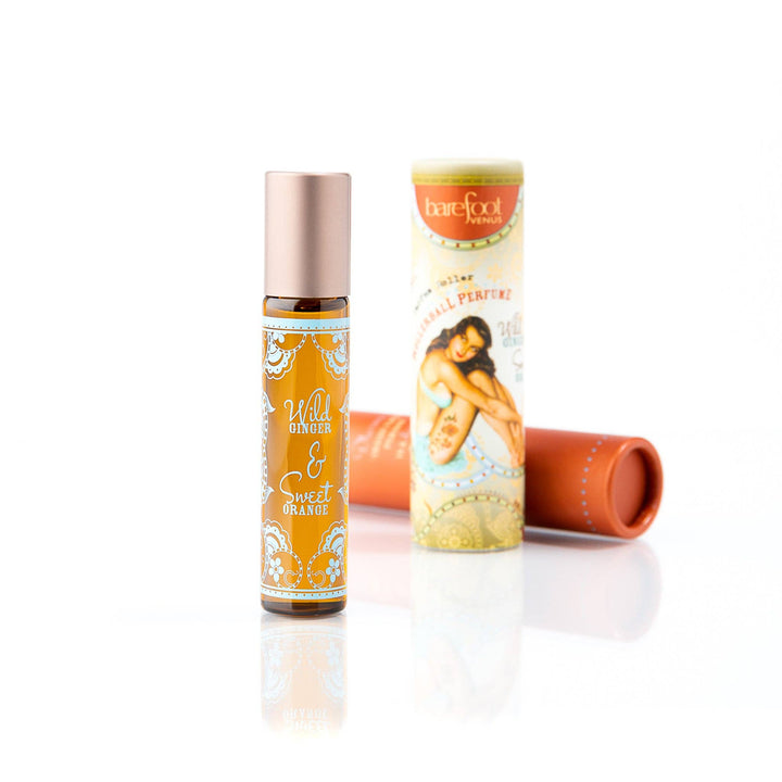 Two bottles of Wild Ginger &amp; Sweet Orange perfume on a white background