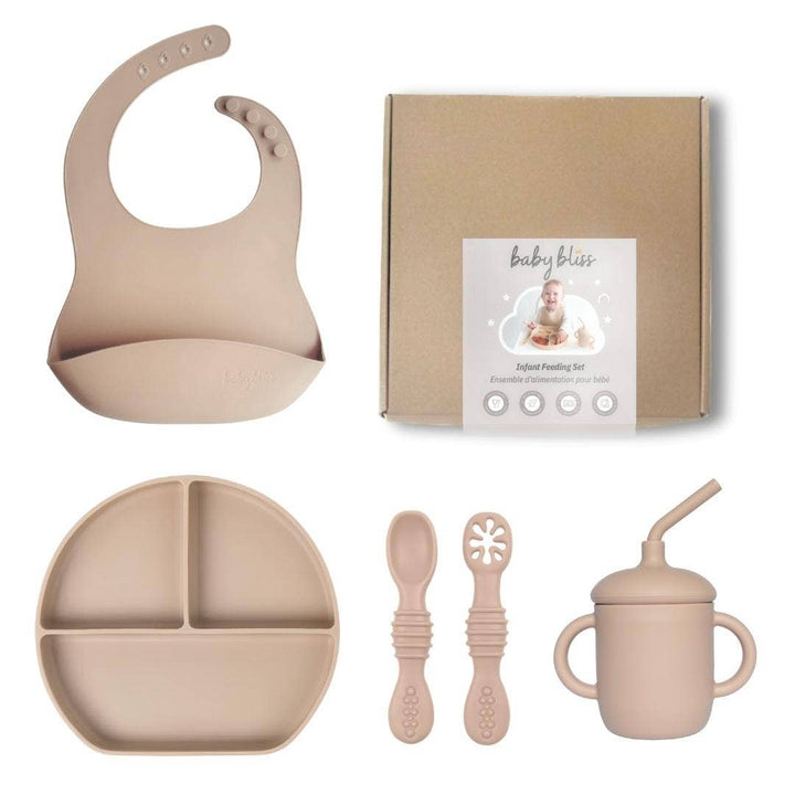 Baby feeding set with bib, plate, cups, and utensils on a white background