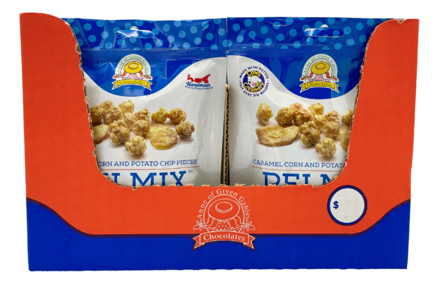 A cardboard display box holding two bags of chocolate-covered cereal pieces. The packaging features a bright blue and orange design with the text 'DELICIOUS DELMOND CHOCOLATE' and 'Caramel, Corn and Potato Chip Pieces' visible on the bags.