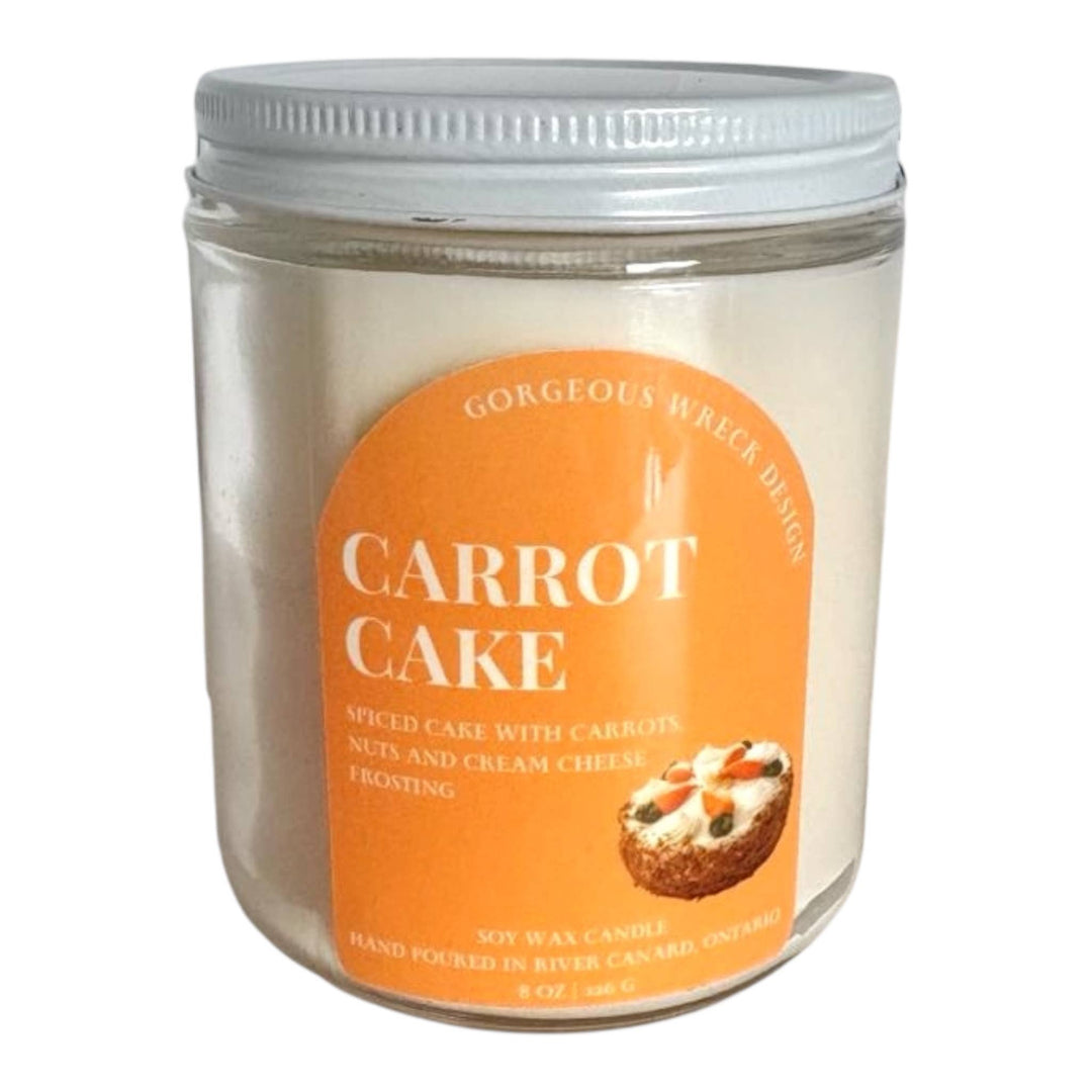 An 8 oz soy wax candle in a clear glass jar with a white screw-on lid and a prominent orange label reading &