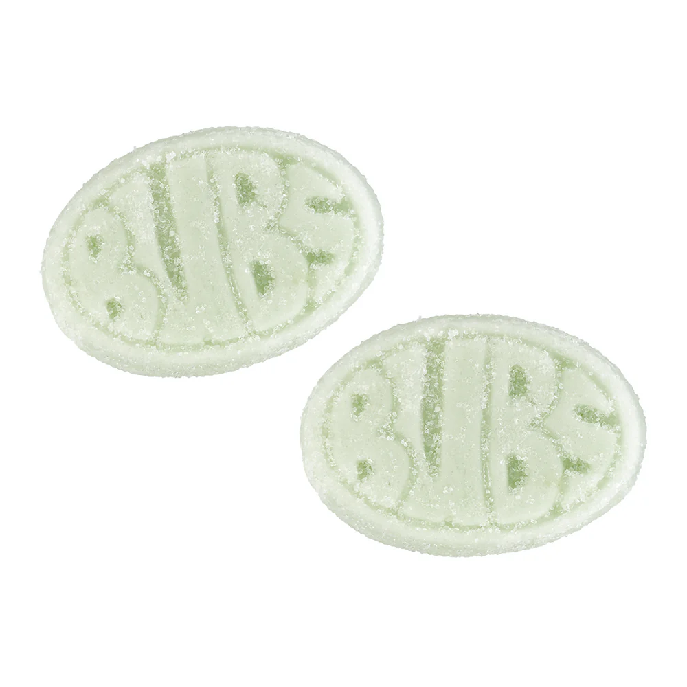 Two oval-shaped green and white bath bombs on a white background