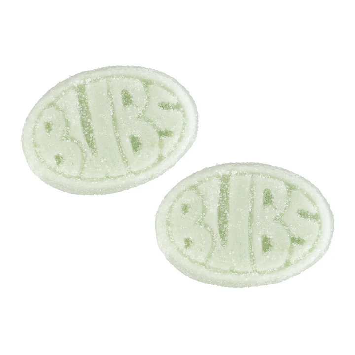 Two oval-shaped green and white bath bombs on a white background
