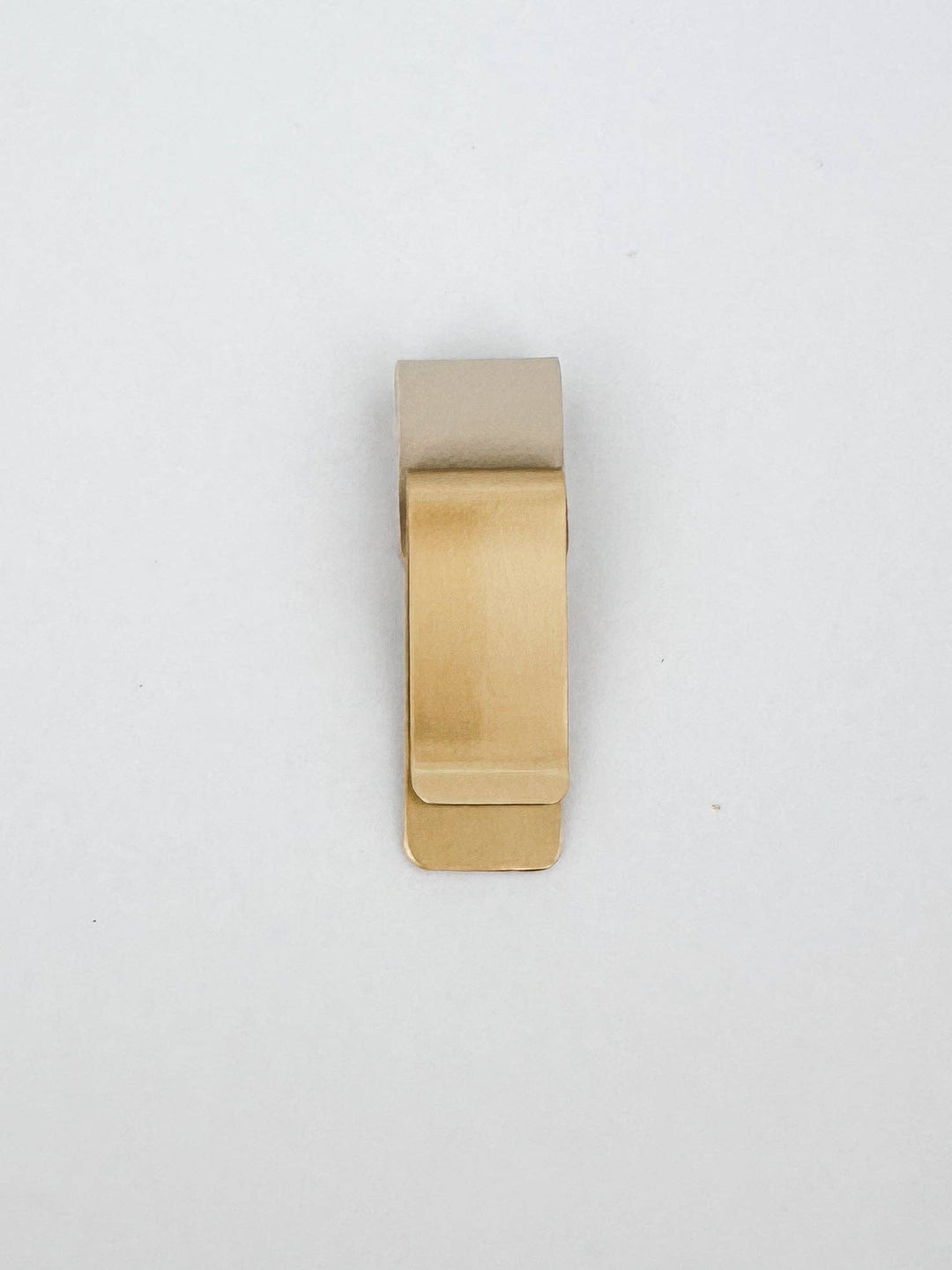 Gold money clip on a white background