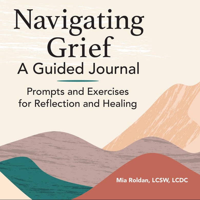 Book cover of 'Navigating Grief: A Guided Journal' with abstract mountain design