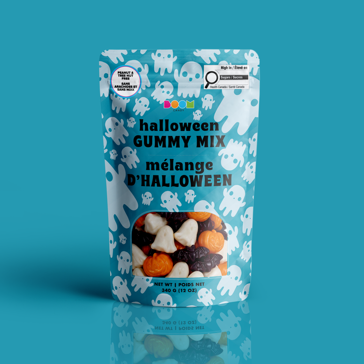 A stand-up pouch of Halloween Gummy Mix with a light blue background, white ghost illustrations, and a clear window showing the candy mix inside. The packaging features the text &