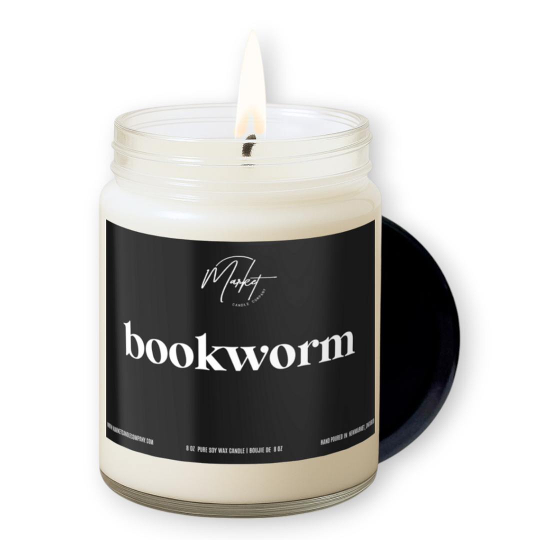 Candle in a jar labeled 'bookworm' on a white background