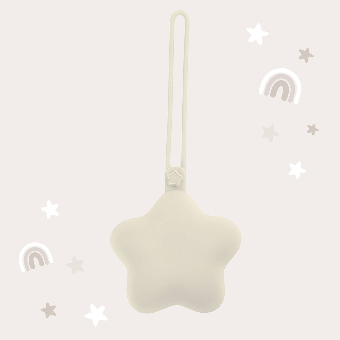 Star-shaped white ornament with a string on a light gray background with decorative elements.