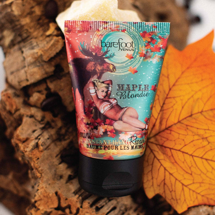 Hand cream tube with colorful packaging on a wooden surface with an orange leaf