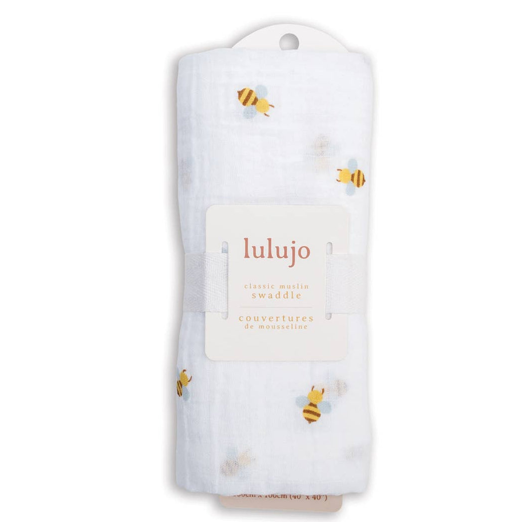 Lulujo baby swaddle with bee pattern on a white background