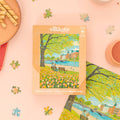 Villager Puzzles Tulip Season 500-piece puzzle featuring colorful tulip fields, designed in Canada, with vibrant floral artwork.