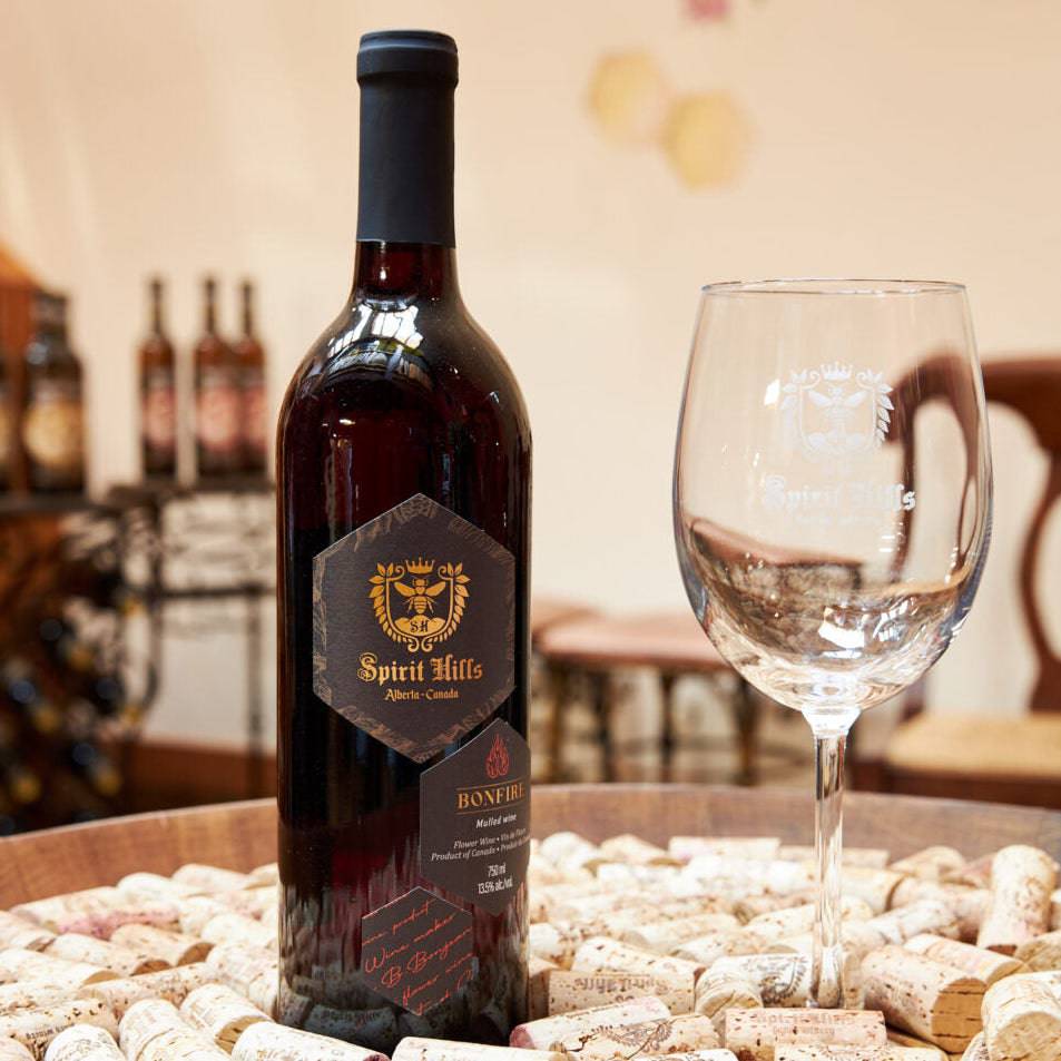 Bottle of Spirit Hills wine with a glass on a table with corks