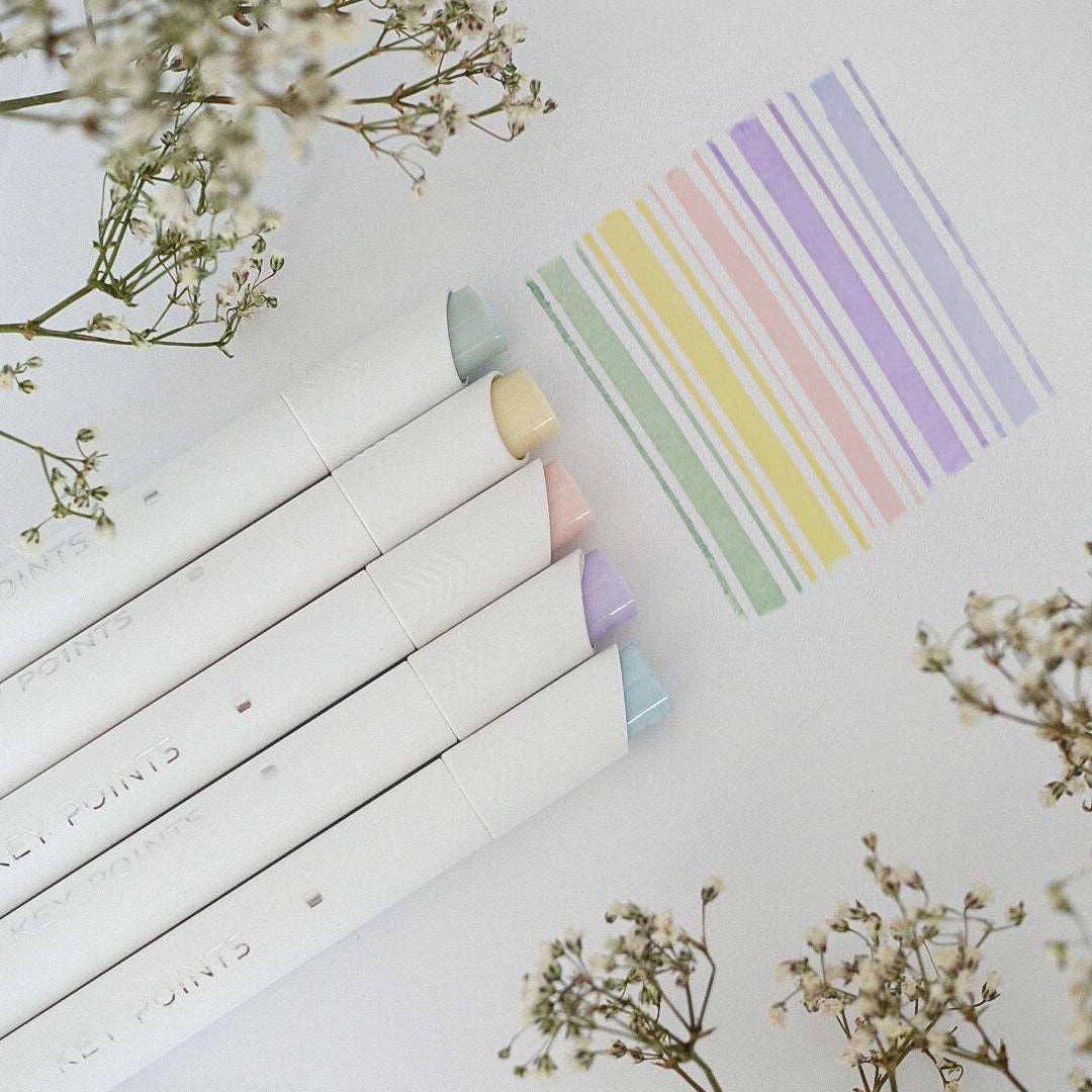 Colorful geometric shapes on a white surface with flowers