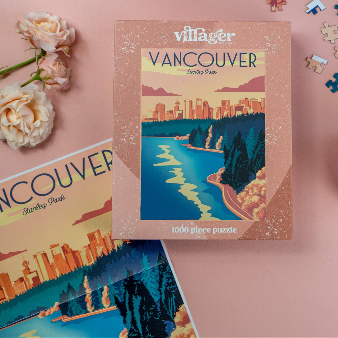 Vancouver-themed puzzle box with scattered puzzle pieces on a pink surface.