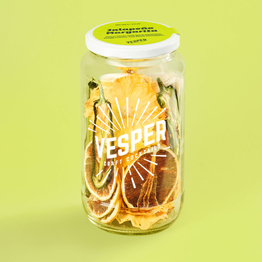 Jar of dried fruit with 'Vesper' branding on a green background