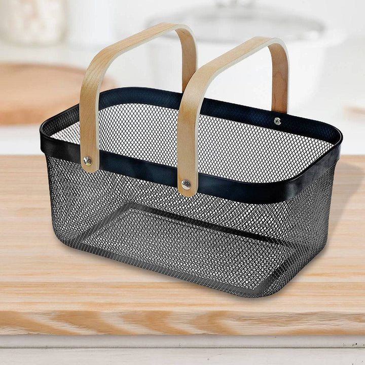 Black mesh basket with wooden handles on a kitchen counter
