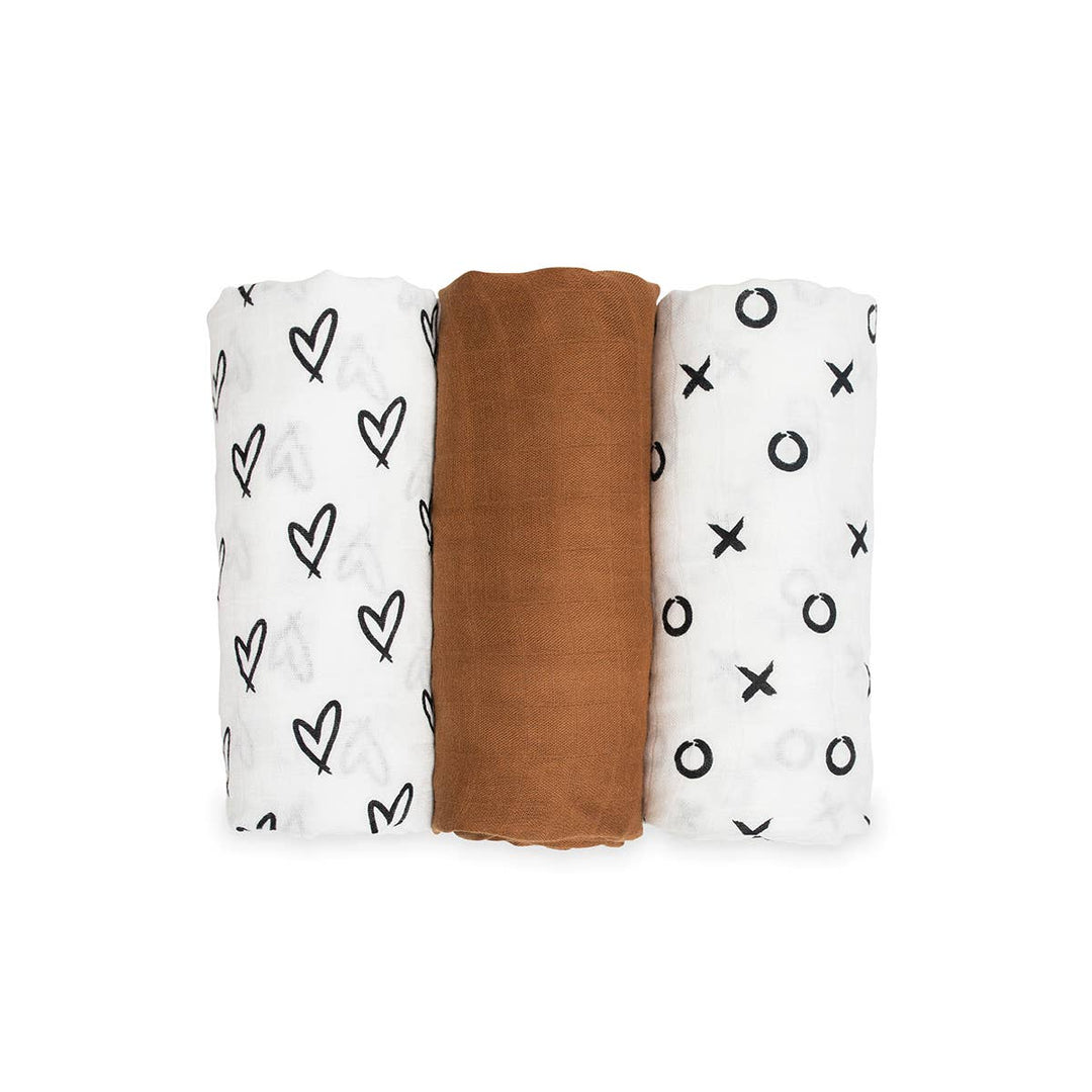 Three swaddle blankets with different patterns on a white background