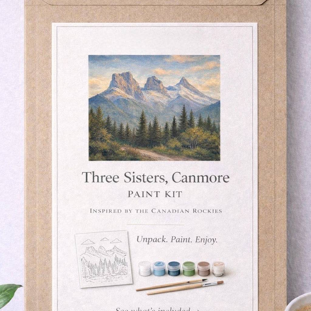 Paint kit packaging with mountain scene and paintbrush illustration on a white background