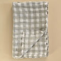 Folded checkered fabric on a beige background