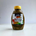 Bottle of Caesar salad dressing on a white background