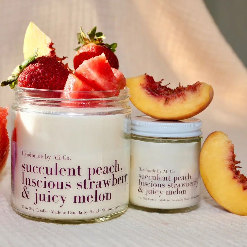Two jars of succulent peach, luscious strawberry &amp; juicy melon scented product with fruit on top.