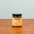 A jar of Rosso Earl Grey tea with a creamy bergamot flavor, placed on a wooden surface.