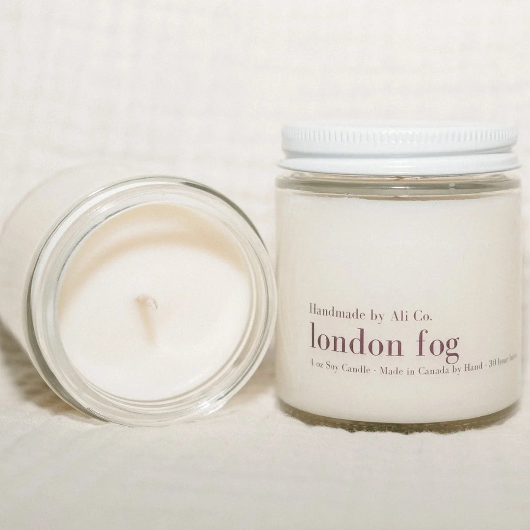 Two candles, one lit and one unlit, with &