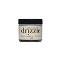 A jar of Drizzle White Honey, 80 grams, with the label showing the brand name and the origin 'Banff, Canada No. 1'.