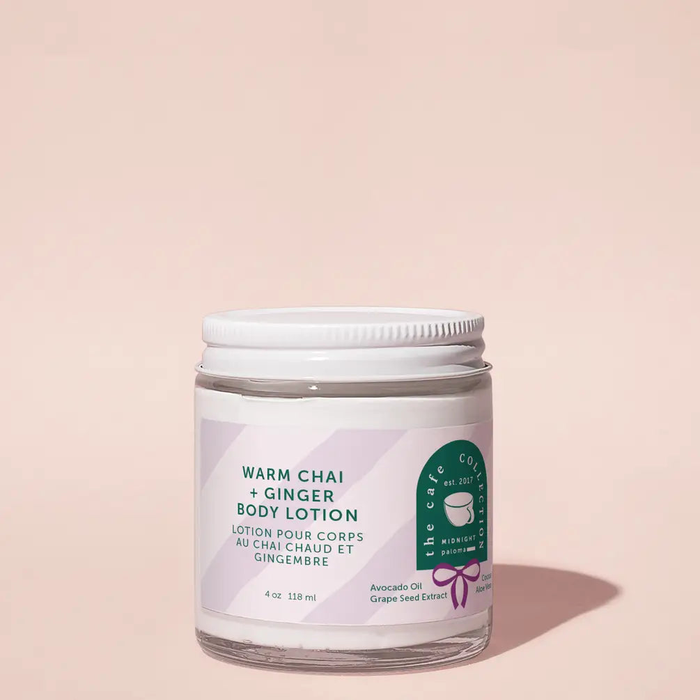 Body lotion jar with a white lid on a light pink background