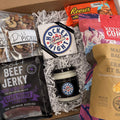 Assorted snack items including beef jerky, cookies, and popcorn in a box.