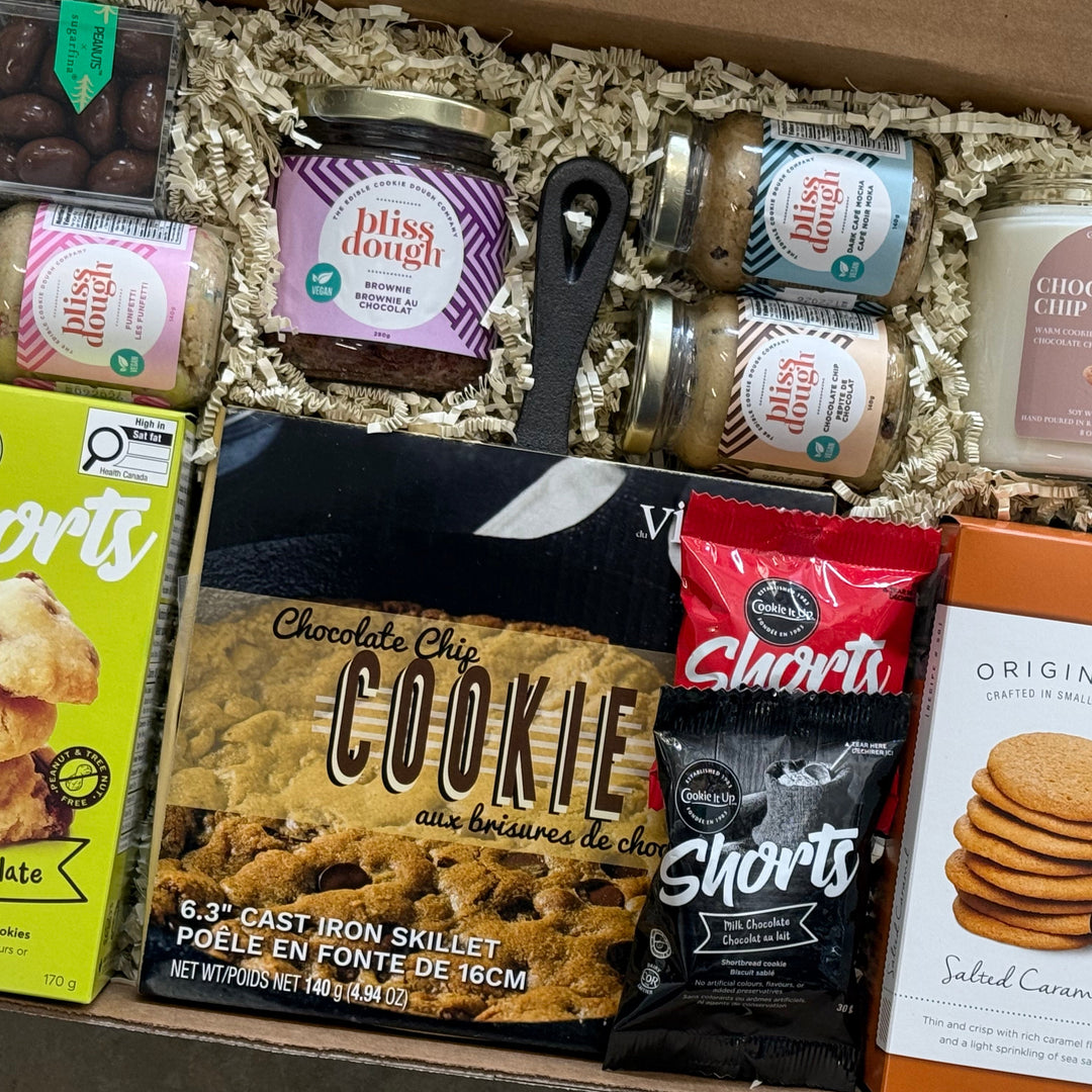 Assorted cookie-themed products in a box including cookies, chocolate, and baking ingredients.