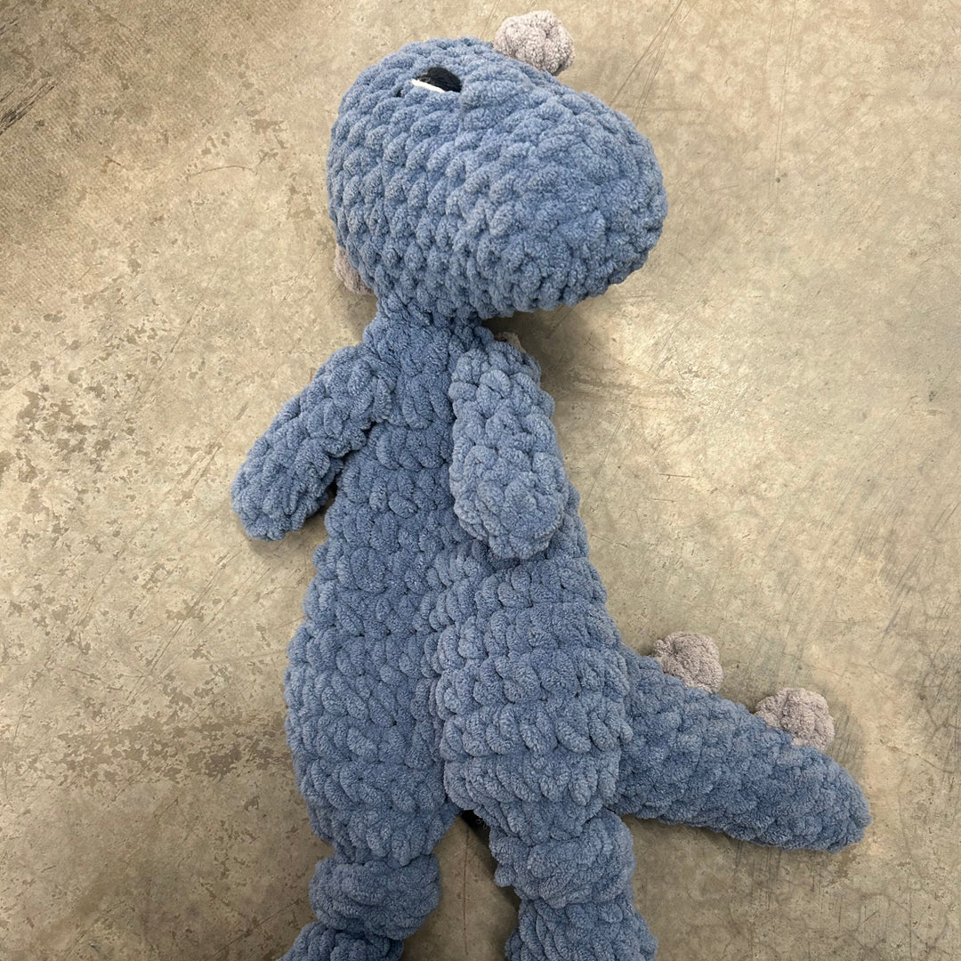 Blue plush toy on a beige carpet