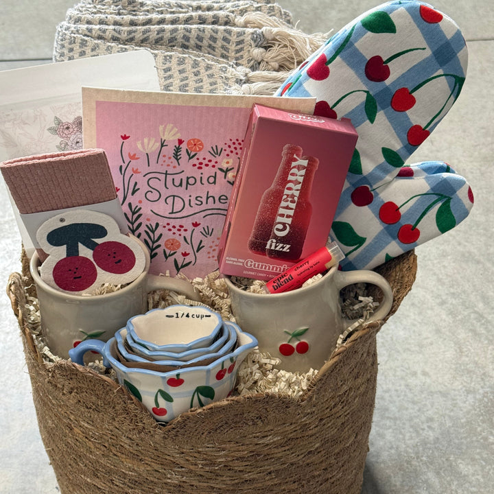 Decorative items including a mug, small cups, and a book on a textured surface.