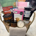 Basket with snacks, a candle, and a sock on a textured surface