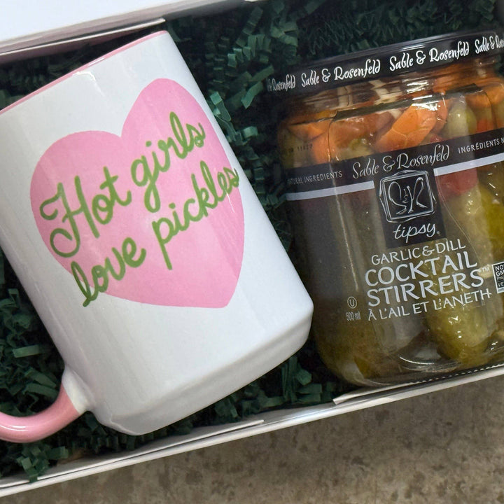 Mug with heart design and text, jar of pickles in a box