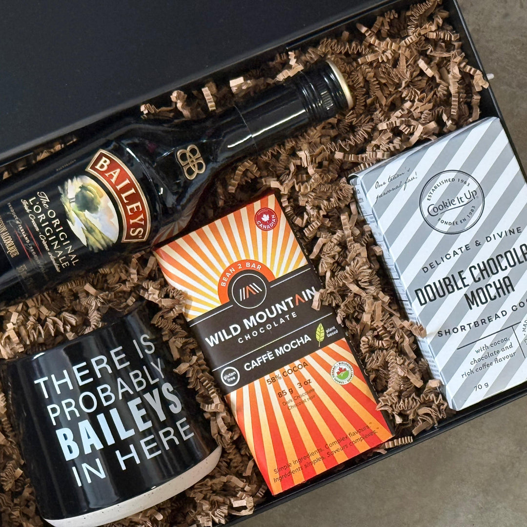 Gift set with Baileys bottle, coffee mug, and cookies in a box.