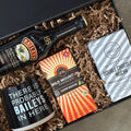 Gift set with Baileys bottle, coffee mug, and cookies in a box.