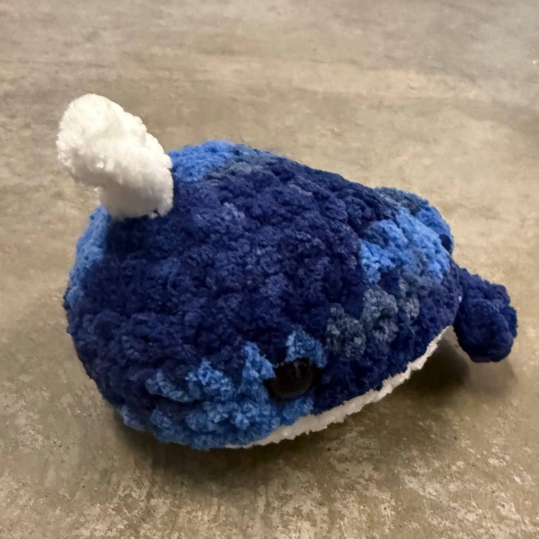 Blue plush toy on a textured beige surface