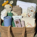 Welcome To The World baby gift basket with plush toys, baby essentials, and decorative items from Gift Smack Gift Company.