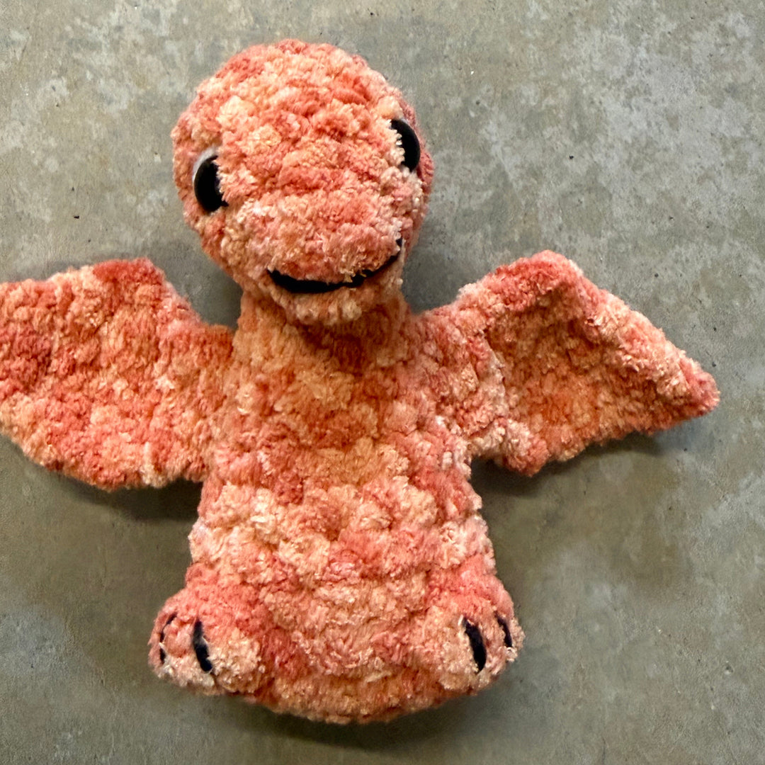 Pink plush toy on a gray concrete surface